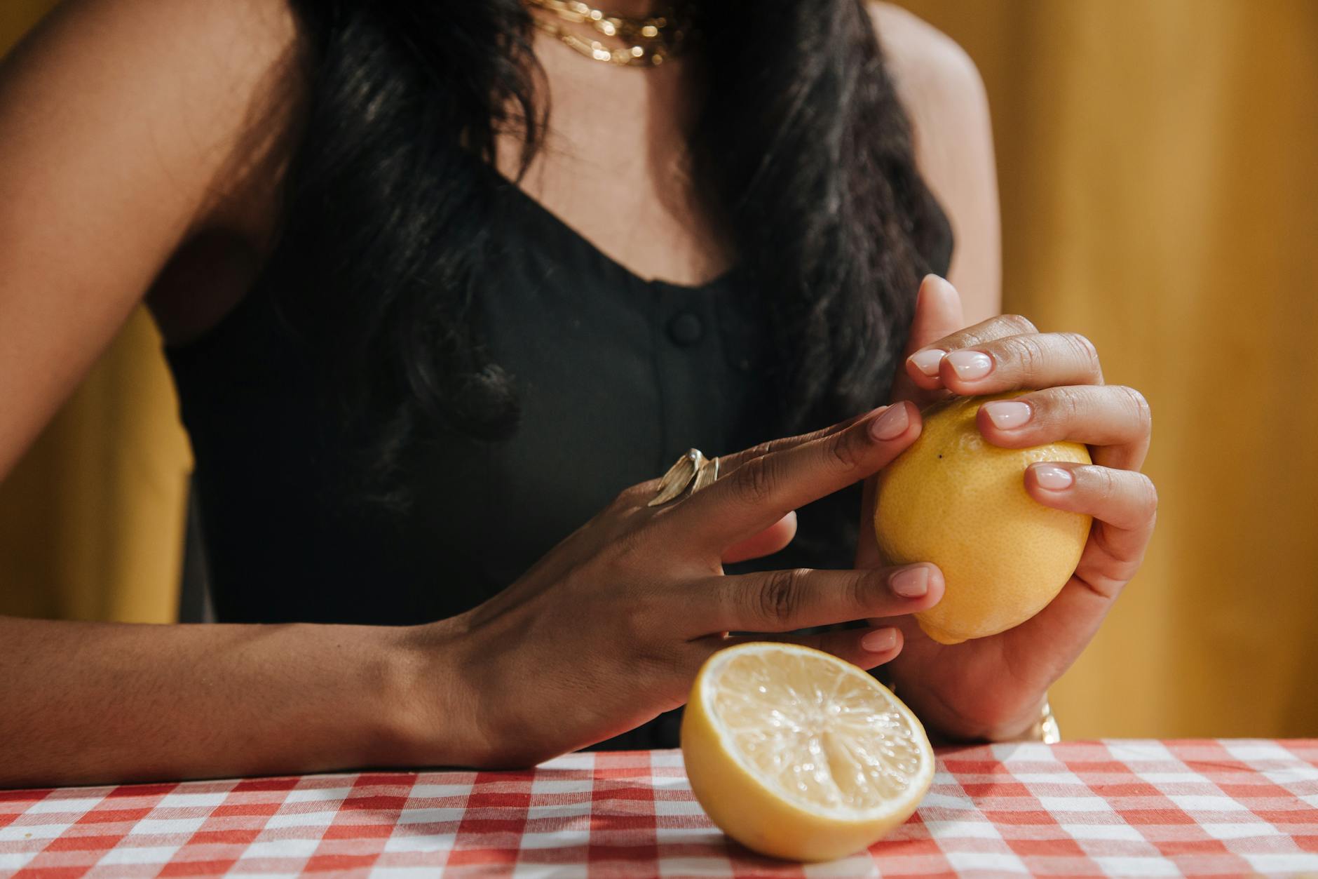 Woman holding blue and pink silicone vibrators, examining texture and sensitivity.